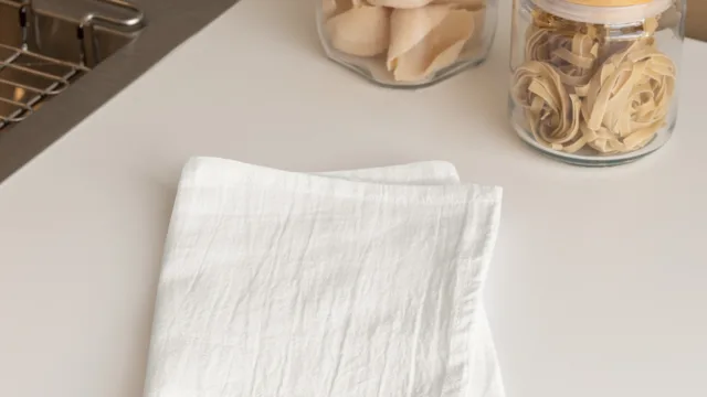 mockup-of-a-tea-towel-lying-on-a-table-near-a-sink-m40742